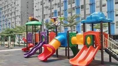 a playground with colorful play equipment in a city at Deca Suites 946 in Manila