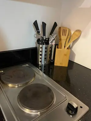 a stove top with two pans on top of it at Casa Del Castillo at Fame Residences near Megamall in Manila