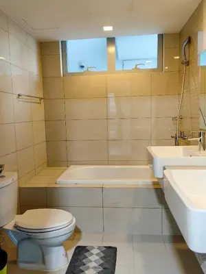 a bathroom with a toilet and a tub and a sink at BGC Uptown Parksuites 2BR Skyline View with Balcony and Bathtub in Manila