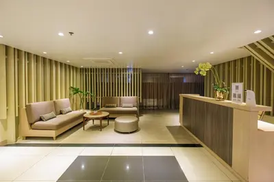 a lobby with two couches and a table at BGC Uptown Parksuites 2BR Skyline View with Balcony and Bathtub in Manila