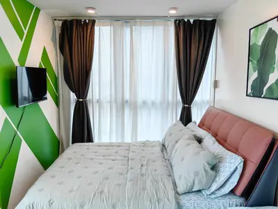 a bedroom with a bed and a large window at BGC Uptown Parksuites 2BR Skyline View with Balcony and Bathtub in Manila