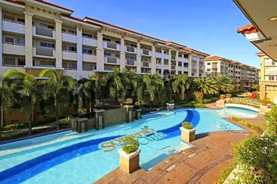 a large swimming pool in front of a building at 2BR Italian-inspired Condo Unit, Balcony Pool View in Manila