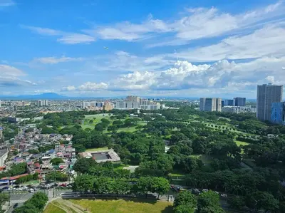 an aerial view of a city with trees and buildings at The Infinity Towers in BGC - Spectacular 2BR near Hight Street in Manila