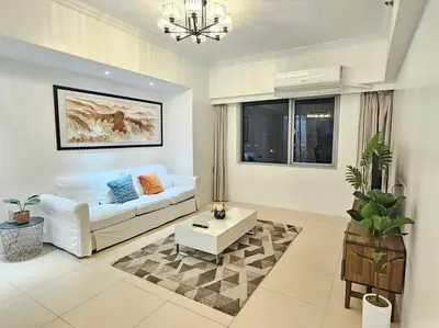 a living room with a couch and a coffee table at The Infinity Towers in BGC - Spectacular 2BR near Hight Street in Manila