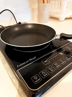 a black frying pan sitting on top of a stove at Hope Stays in Manila