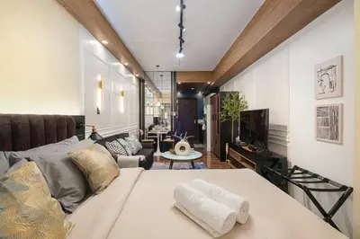 a living room with a bed and a couch at Air Residences, SMDC, Makati in Manila