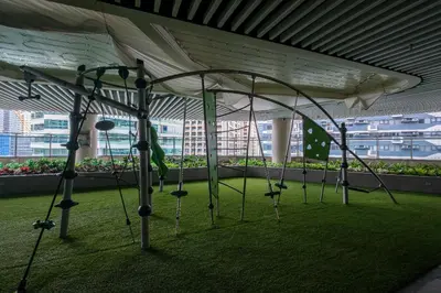 a group of swings in a room with a roof at Air Residences, SMDC, Makati in Manila