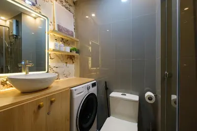 a bathroom with a sink and a washing machine at Air Residences, SMDC, Makati in Manila