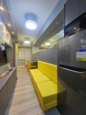 a lobby with a yellow bench in an office at S Residences Luxury Unit in Manila