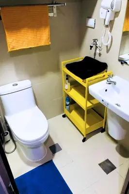 a bathroom with a white toilet and a sink at S Residences Luxury Unit in Manila