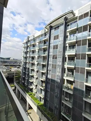 a tall apartment building with windows on a balcony at LDN Secret Crib - Newport City in Manila