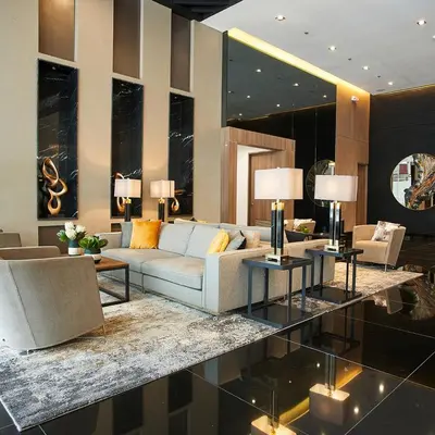 a living room with a couch and tables and chairs at FCMCO Condotel in Manila