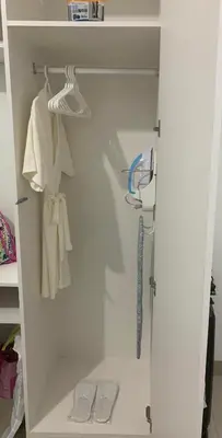 a white closet with two pairs of shoes in it at Humpreys Comforts in Manila