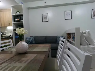 a living room with a couch and a table at Humpreys Comforts in Manila