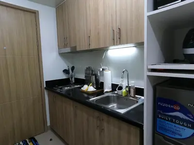 a kitchen with a sink and a counter top at Humpreys Comforts in Manila