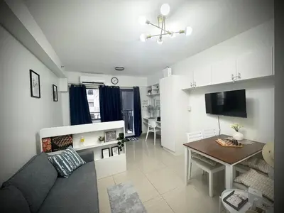 a living room with a couch and a table at Humpreys Comforts in Manila
