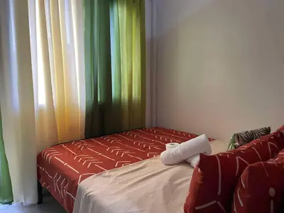 a room with a bed and a window with curtains at Lush Residences Makati City by darpm in Manila