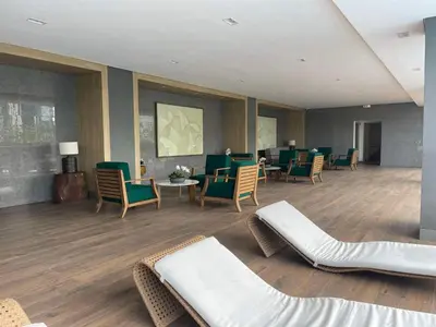 a waiting room with chairs and a couch and tables at Lush Residences Makati City by darpm in Manila