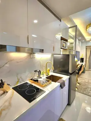a kitchen with a sink and a stove top oven at Sky PortLuxe Studio Near MOA in Manila