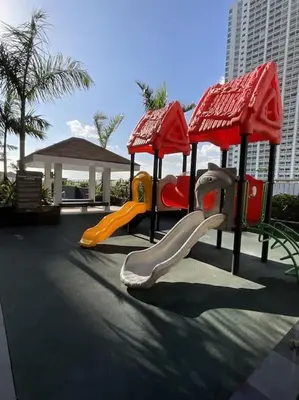 a playground with a slide in a park at Sky PortLuxe Studio Near MOA in Manila