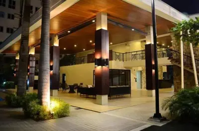 a large house with a balcony and a staircase at The Rochester, Bridgeview Tower - 1BR Apartment in Manila