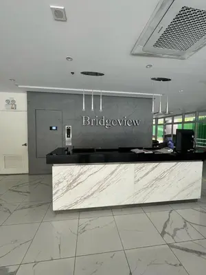 a lobby with a reception desk in a building at The Rochester, Bridgeview Tower - 1BR Apartment in Manila
