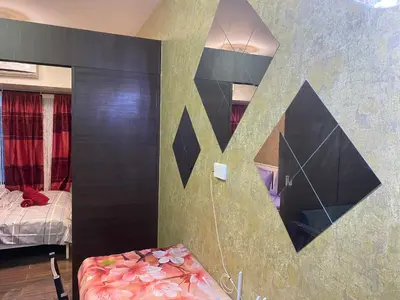 a bedroom with a bed and a mirror on the wall at Penthouse Fantasy in Manila