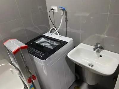 a small white bathroom with a sink and a toaster at Penthouse Fantasy in Manila