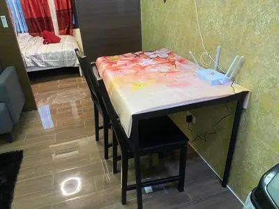 a table with a table cloth on it with a bed at Penthouse Fantasy in Manila