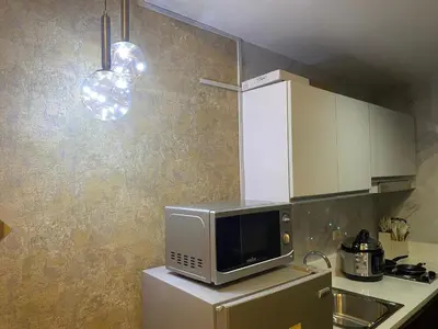 a kitchen with a microwave on top of a refrigerator at Penthouse Fantasy in Manila