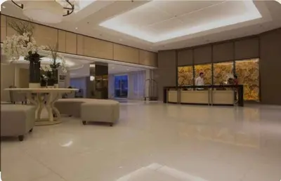 a large room with a lobby with a table and chairs at Shell Residences Staycation near SM MOA in Manila