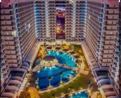 an aerial view of a large building with a pool at Shell Residences Staycation near SM MOA in Manila