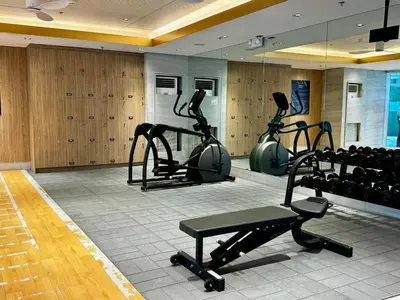 a gym with treadmills and exercise bikes in a room at Casa Fama - Fame Residences Staycation in Manila