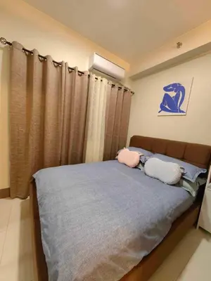 a bedroom with a bed with two pillows on it at Casa Fama - Fame Residences Staycation in Manila