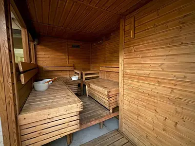 an empty wooden sauna with wooden benches in it at Lido De Paris Hotel in Manila