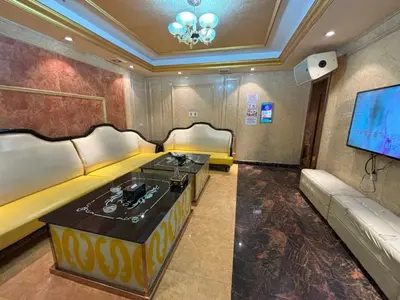 a living room with two couches and a flat screen tv at Lido De Paris Hotel in Manila