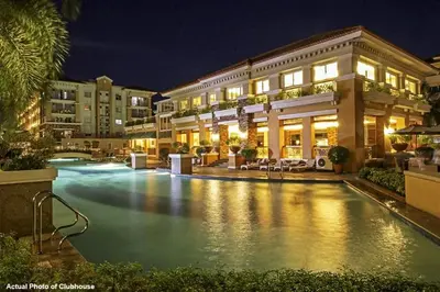a pool in front of a building at night at Your Comfort Zone Staycation1 in Manila