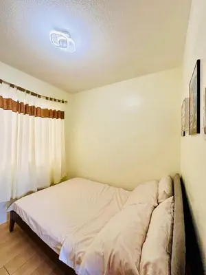 a bedroom with a bed in a room at Your Comfort Zone Staycation1 in Manila