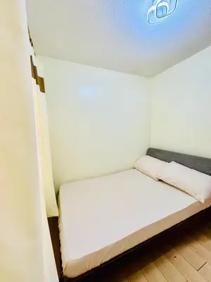 a small room with a white bed in it at Your Comfort Zone Staycation1 in Manila