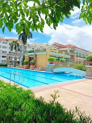 a swimming pool in front of a building at Your Comfort Zone Staycation1 in Manila