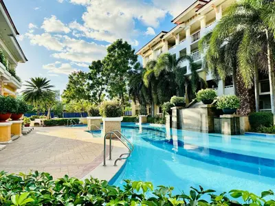a swimming pool in front of a building at Your Comfort Zone Staycation1 in Manila