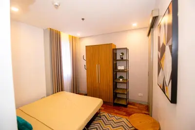 a small room with a bed and a book shelf at Antel Spa & Serenity Suites in Manila