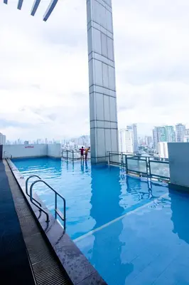a swimming pool on the roof of a building at Antel Spa & Serenity Suites in Manila