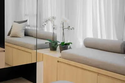 a room with two benches with flowers on them at Eastwood City Cozy Designer Studio Long Stay Friendly Walk to Mall in Manila