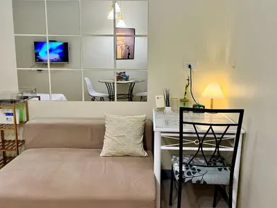 a living room with a couch and a table at Staycation Condotels for Travellers Near Airport in Manila