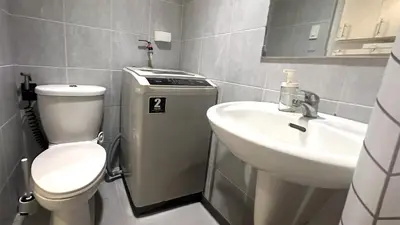 a small bathroom with a toilet and a sink at South Pad Staycation Sea Residences SM Mall of Asia Tower A, B and E in Manila