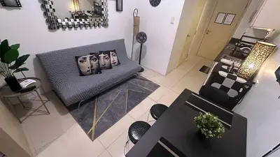 an overhead view of a living room with a couch and chairs at South Pad Staycation Sea Residences SM Mall of Asia Tower A, B and E in Manila