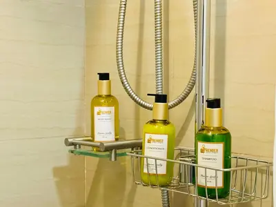 two bottles of wine in a rack in a bathroom at Shore Residences by Premier Suites in Manila