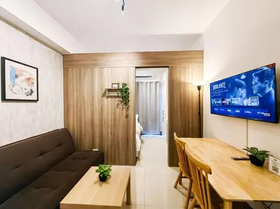 a living room with a couch and a table at 1BR Condotel with Balcony at FAME Residences #FM16 in Manila