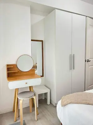 a bedroom with a dressing table and a mirror at Azure Luxury Suite in Manila
